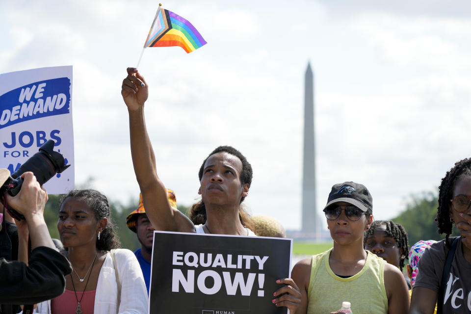 FILE - People listen to speakers during the 60th anniversary of the March on Washington at the Lincoln Memorial in Washington, Aug. 26, 2023. On the 60th anniversary of the March on Washington, speakers called attention to a nationwide backlash against LGBTQ+ rights. But some Black LGBTQ+ participants felt that their early speaking slots minimized their contributions and reflected historical erasure of Black queer people in the Civil Rights Movement. (AP Photo/Jacquelyn Martin, File)