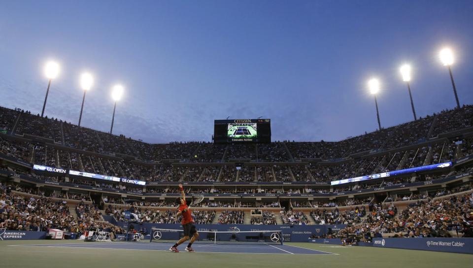 Novak Djokovic of Serbia serves to Rafael Nadal of Spain during their men's final match at the U.S. Open tennis championships in New York, September 9, 2013. REUTERS/Ray Stubblebine (UNITED STATES - Tags: SPORT TENNIS)