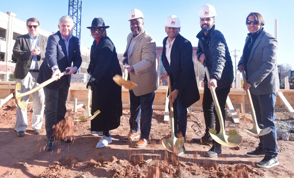 A groundbreaking was held for the new Fairfield Inn & Suites hotel in Spartanburg on Dec. 18, 2023. The new hotel will be on St. John Street next to the Montgomery Building. (L-R) Spartanburg city manager Chris Story, city councilmembers Jamie Fulmer District 4, Janie Salley District 5, Spartanburg Mayor Jerome Rice, broke ground with Hawkeye Hotels officials Siuraj Mistry, Samir Patel, and Om Patel in front of the site of the new hotel.