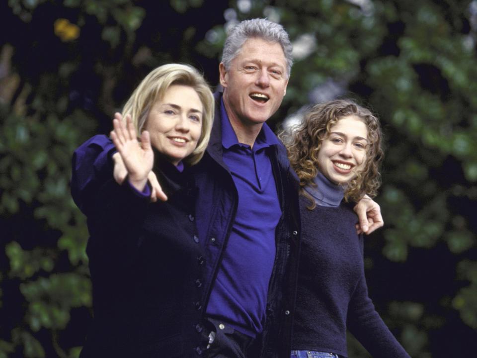 Bill, Hillary, and Chelsea Clinton walk arm in arm