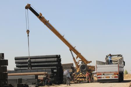 A crane lifts iron in the town of Zakho, Iraq October 11, 2017. REUTERS/Ari Jalal