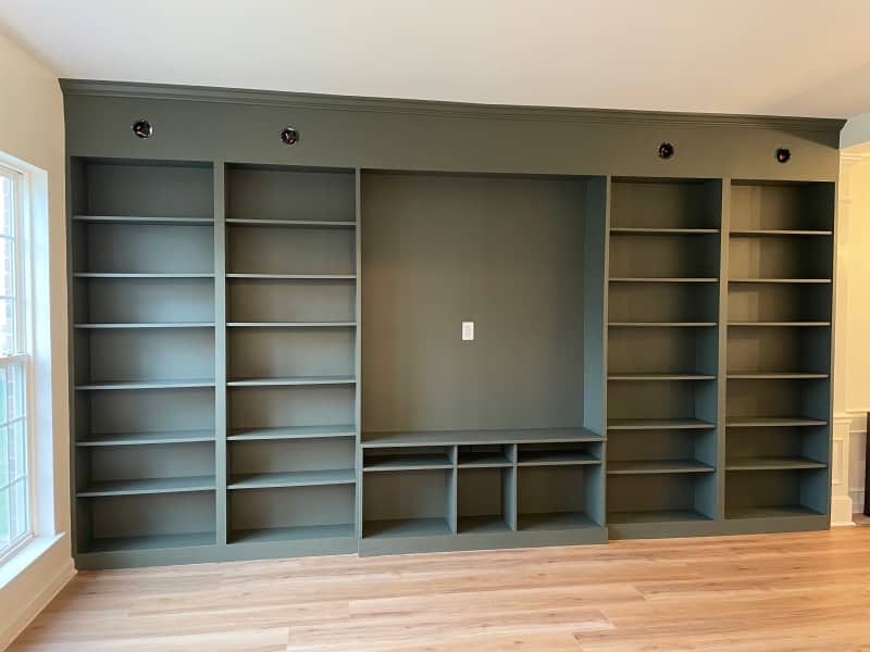 Green Ikea Billy bookcase in living room before filling with books.