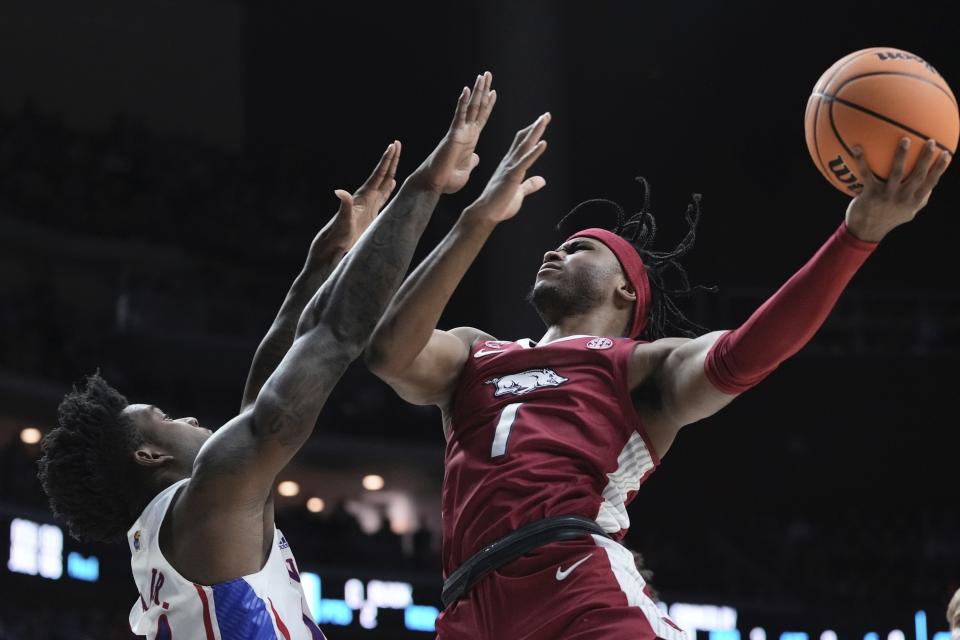 Arkansas' Ricky Council IV shoots past Kansas' K.J. Adams Jr. during the second half of a second-round college basketball game in the NCAA Tournament Saturday, March 18, 2023, in Des Moines, Iowa. (AP Photo/Morry Gash)