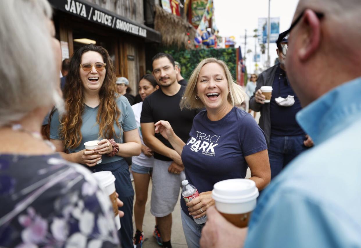 Traci Park, candidate for City Council in the 11th District, center, mingles with voters at the Cow's End Cafe in Venice.