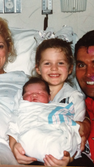 Allie LaForce is six years older than her sister, AuBree, whom she is holding in this family photo.