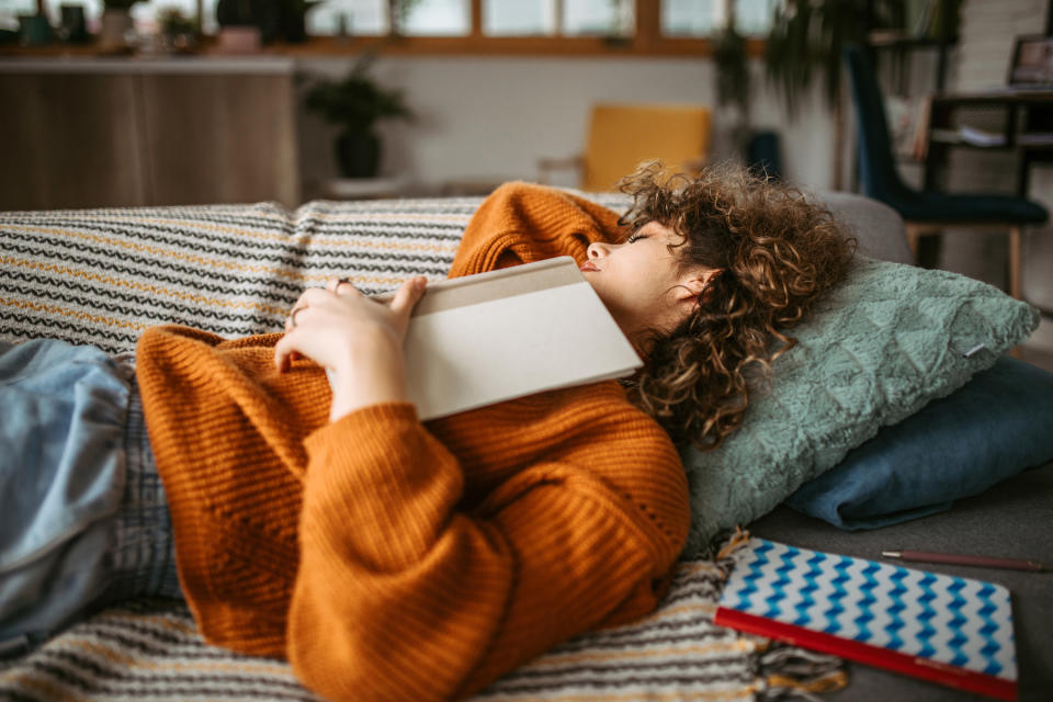 A  student taking a nap between studying