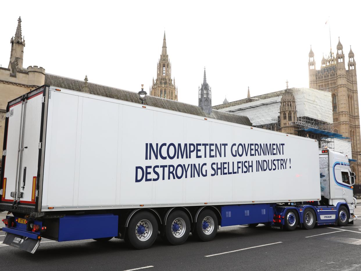  A lorry featuring a message accusing the government of incompetence passes in front of the Houses of Parliament to protest on Monday (Getty)