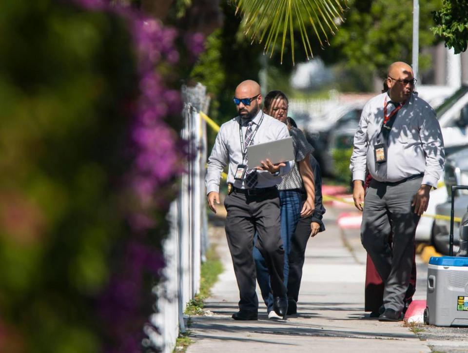 Police officers work a crime scene near 7920 East Dr. on Monday, Nov. 28, 2022, in North Bay Village, Fla. A man was killed, a woman was wounded and another man is in custody following a domestic-related shooting, authorities said.