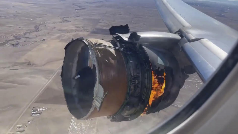 FILE - In this image taken from video, the engine of United Airlines Flight 328 is on fire after after experiencing "a right-engine failure" shortly after takeoff from Denver International Airport, Saturday, Feb. 20, 2021, in Denver, Colo. Federal safety officials are updating their investigation into the engine failure on the United Airlines plane that sent parts of the engine housing raining down on Denver-area neighborhoods last month. The National Transportation Safety Board said Friday, March 5, that a microscopic exam confirmed that a fan blade that snapped off had telltale signs of fatigue — tiny cracks caused by wear and tear. (Chad Schnell via AP)