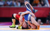 LONDON, ENGLAND - AUGUST 06: Ivo Serafimov Angelov of Bulgaria competes against Jiang Sheng of China (L) during the Men's Greco-Roman 60 kg Wrestling Repechage on Day 10 of the London 2012 Olympic Games at ExCeL on August 6, 2012 in London, England. (Photo by Cameron Spencer/Getty Images)