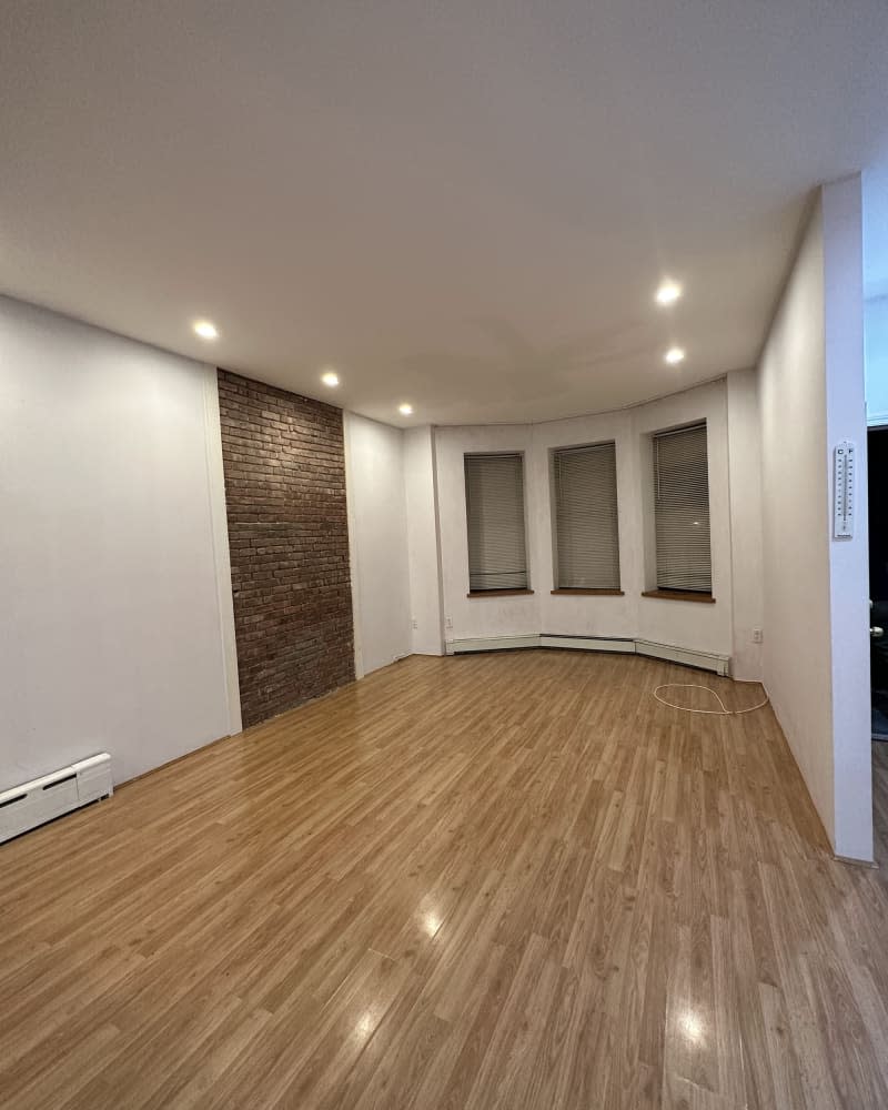 Empty white living room that's been repainted right before moving out