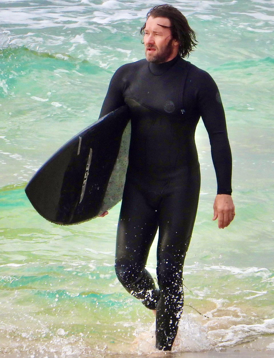 <p>Joel Edgerton shows off his longer locks as he catches some waves at Australia's Bondi Beach on Monday.</p>