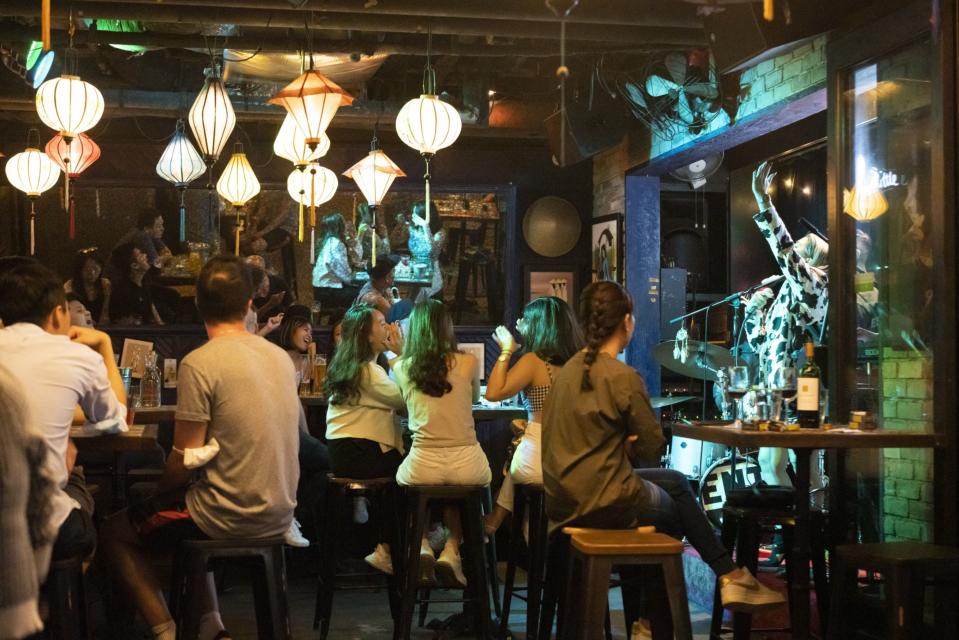 Customers listen to a band at a bar in the Clarke Quay area in Singapore.