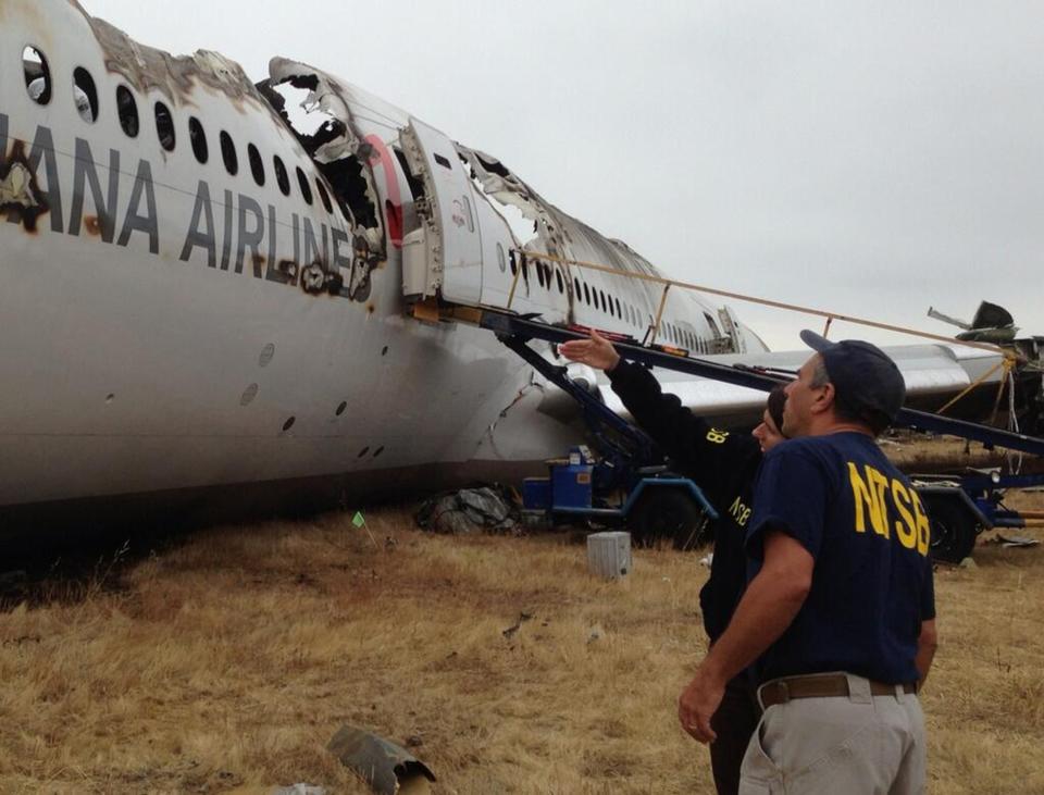 The National Transportation Safety Board (NTSB) Investigator in Charge Bill English (R) and Chairman Deborah Hersman discuss the progress of the Asiana Airlines flight 214 investigation in San Francisco, California, in this file picture provided by NTSB on July 9, 2013. U.S. safety investigators are looking closely at whether an over-reliance on autopilot systems in modern aircraft has degraded human flying skills, increasing the risk of accidents. At a two-day hearing that starts on December 10, 2013, the NTSB will examine if cockpit complacency caused the Asiana Airlines Inc's jetliner with 307 people aboard to crash land at San Francisco International Airport in July, killing three and injuring more than 180. (REUTERS/NTSB/Handout via Reuters/Files)