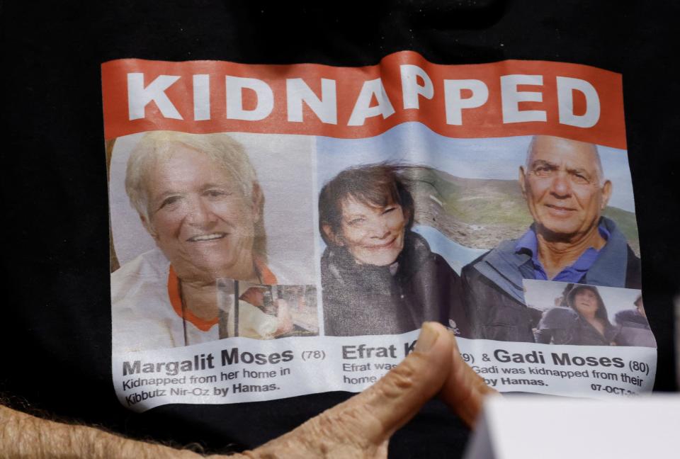 Chanan Cohen shows a picture of his sister Margalit Berta Moses and her ex-husband Gad Moshe Moses during a press conference with family members of Israeli hostages taken by Hamas in the Oct. 7 attack, at the Israeli Consulate in Munich, Germany, on Nov. 13, 2023. / Credit: MICHAELA REHLE/AFP via Getty Images