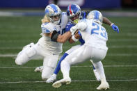 New York Giants wide receiver Wan'Dale Robinson (17) is tackled on the run by Detroit Lions linebacker Alex Anzalone (34) and cornerback Mike Hughes (23) during the second half of an NFL football game, Sunday, Nov. 20, 2022, in East Rutherford, N.J. (AP Photo/Seth Wenig)