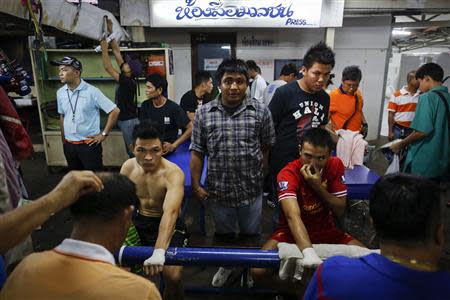 Fighters get ready for the closing Thai boxing, or "Muay Thai", fight night of the legendary Lumpinee stadium, one of Bangkok's oldest boxing venues which is being demolished after 57 years, February 7, 2014. REUTERS/Damir Sagolj