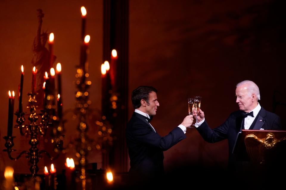 President Joe Biden and French President Emmanuel Macron toast during a State Dinner on the South Lawn of the White House in Washington, Thursday, Dec. 1, 2022. 