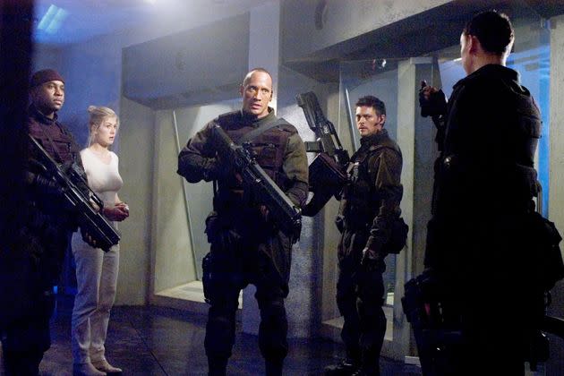 Yep, Rosamund shared the screen with The Rock in 2005's Doom