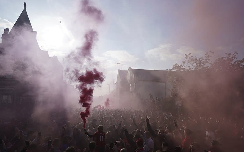 Liverpool fans let off flares ahead of the first Champions League semifinal soccer match between Liverpool and Villarreal at Anfield stadium in Liverpool, England, on April 27. <em>Associated Press/Jon Super</em>