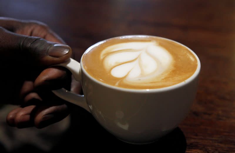 A cup of cappuccino coffee is prepared at a Nairobi Java House outlet in Nairobi