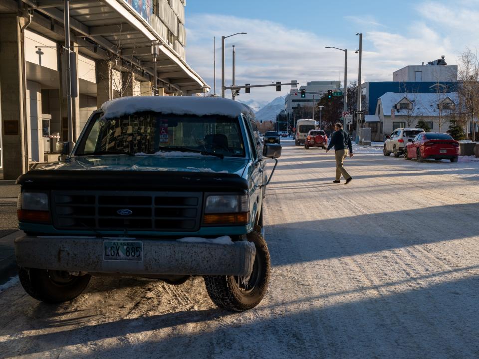 People walk through a snowy downtown on November 04, 2022 in Anchorage, Alaska.