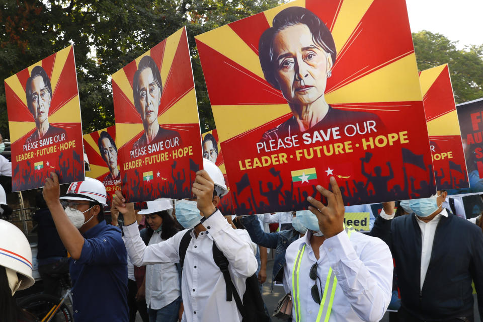 FILE - In this Feb. 15, 2021, file photo, engineers hold posters with an image of deposed Myanmar leader Aung San Suu Kyi as they hold an anti-coup protest march in Mandalay, Myanmar. The military takeover of Myanmar early in the morning of Feb. 1 reversed the country's slow climb toward democracy after five decades of army rule. But Myanmar's citizens were not shy about demanding their democracy be restored. (AP Photo, File)