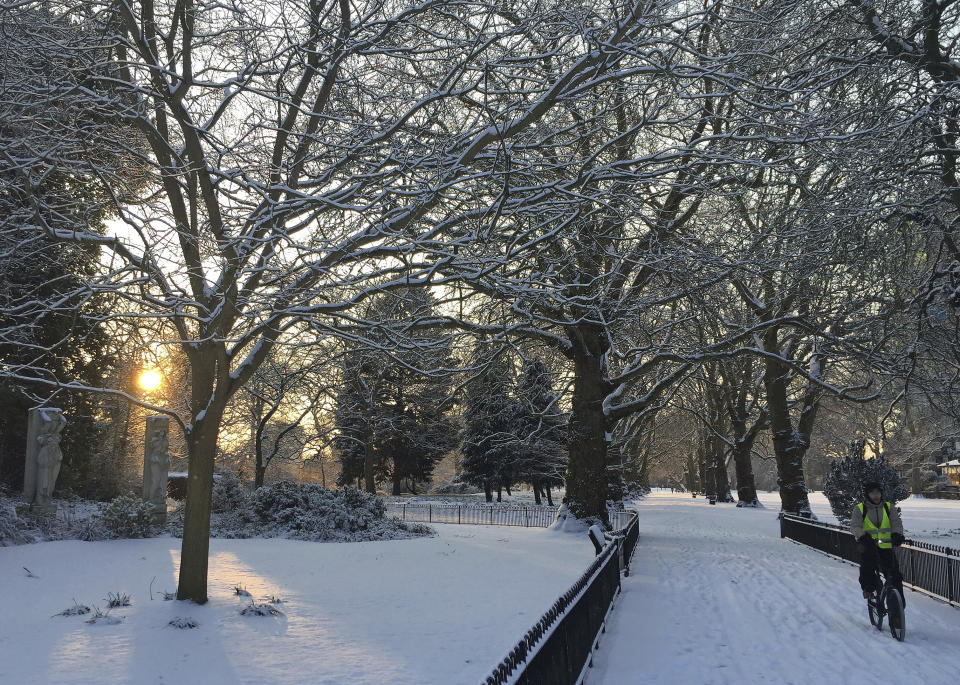 Heavy snow in parts of Britain is causing disruptions to road, rail and air travel and has forced hundreds of schools across the country to close. (AP Photo/Tony Hicks)