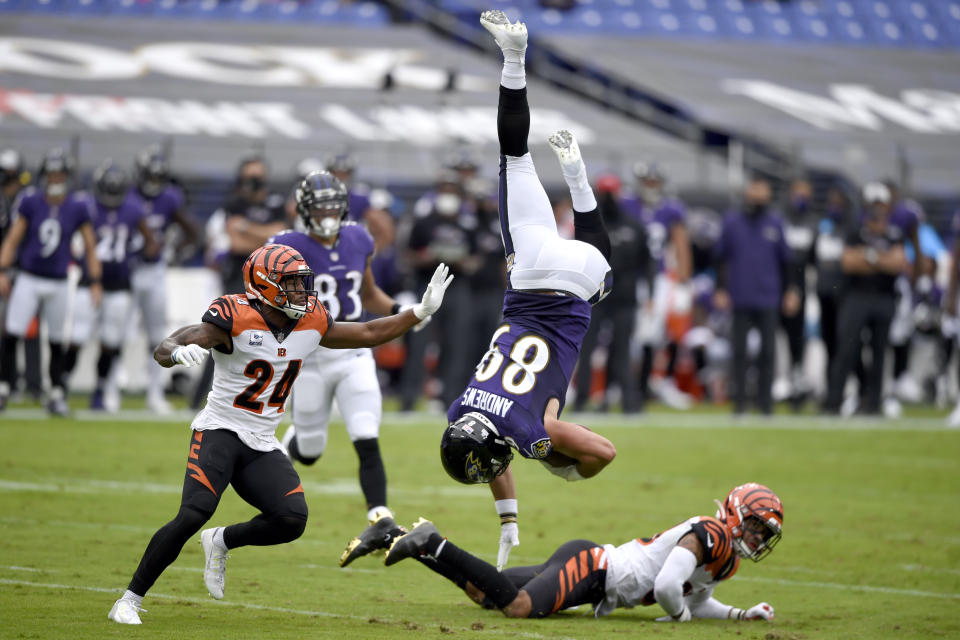 Baltimore Ravens tight end Mark Andrews (89) is upended by Cincinnati Bengals free safety Jessie Bates, right, after making a catch during the first half of an NFL football game, Sunday, Oct. 11, 2020, in Baltimore. (AP Photo/Gail Burton)