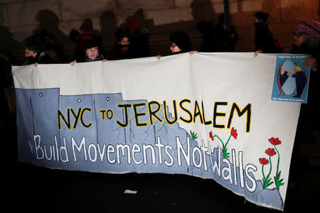 Demonstrators hold a banner during a "Muslim and Jewish Solidarity" protest against the policies of U.S. President Donald Trump and Israeli Prime Minister Benjamin Netanyahu at Grand Central Terminal in New York City, U.S., February 15, 2017. REUTERS/Mike Segar