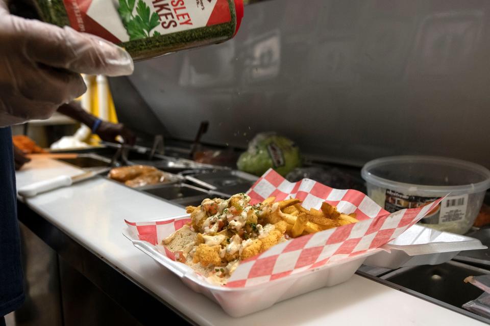 A catfish po'boy is prepared at the newly opened Peoria location of Anchor's Away seafood restaurant on Oct. 20, 2021.