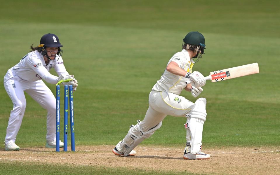 Australia batter Beth Mooney survives a stumping chance by Amy Jones