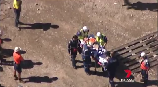 Paramedics attend to a Sydney man after being injured at work. photo: 7 News