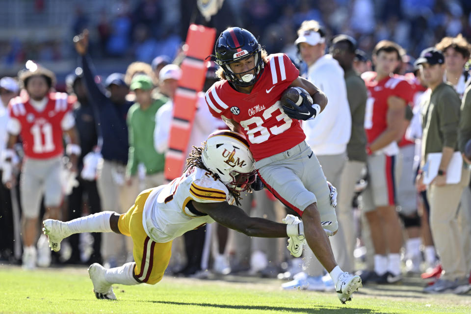 Mississippi wide receiver Cayden Lee (83) avoids Louisiana Monroe linebacker Max Harris (24) during the second half of an NCAA college football game in Oxford, Miss., Saturday, Nov. 18, 2023. Mississippi won 35-3. (AP Photo/Thomas Graning)