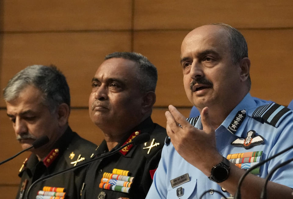 Indian Air Force Chief Air Chief Marshal V R Chaudhari speaks with Indian Army chief General Manoj Pande seated beside him during the launch of Agnipath Scheme, in New Delhi, Tuesday, June 14, 2022. The Agnipath is a merit based recruitment scheme for enrolling soldiers, airmen and sailors. The Scheme provides an opportunity for the youth to serve in the regular cadre of the armed forces for a duration of four years. (AP Photo/Manish Swarup)