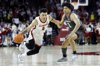 Alabama guard Jahvon Quinerly (5) drives the ball against Oklahoma forward Jalen Hill (1) during the first half of an NCAA college basketball game Saturday, Jan. 28, 2023, in Norman, Okla. (AP Photo/Garett Fisbeck)