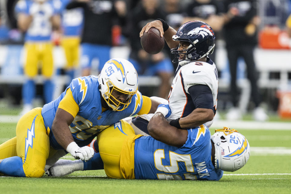 Los Angeles Chargers linebacker Khalil Mack (52) sacks Denver Broncos quarterback Russell Wilson (3). (AP Photo/Kyusung Gong)