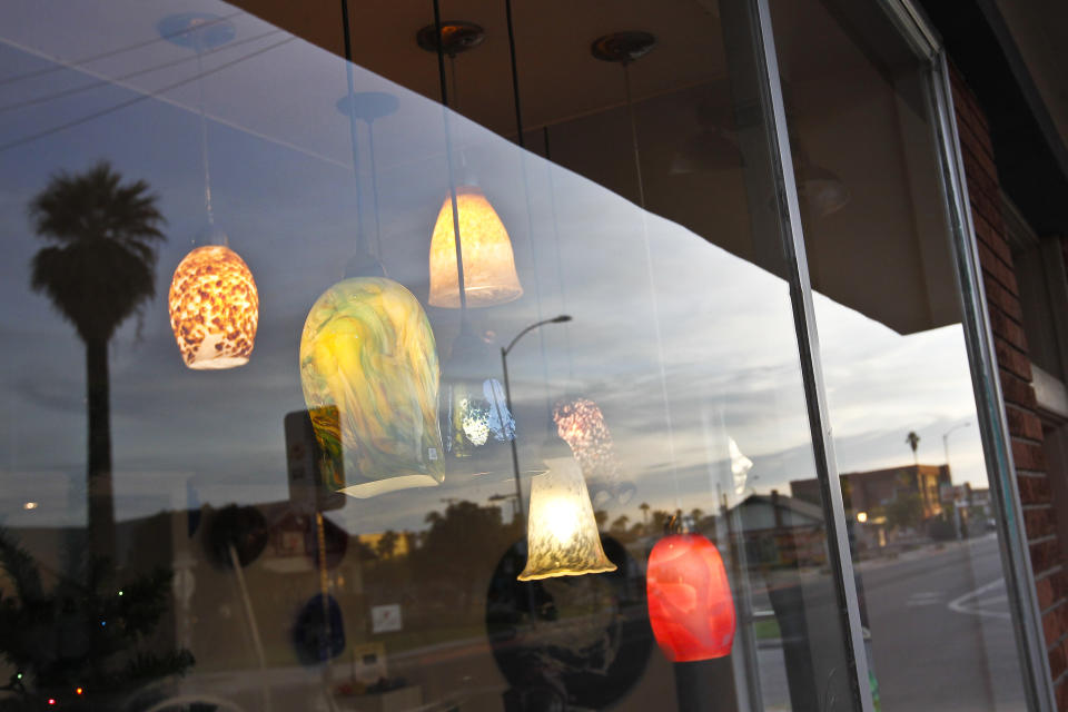 A local shop displays a variety of pendant lights on Roosevelt Street along the Roosevelt Row neighborhood Tuesday, Nov. 27, 2012, in Phoenix. The neighborhood is home to First Friday Art Walk, a Phoenix tradition since 1994, promoting local artists and shops.(AP Photo/Ross D. Franklin)