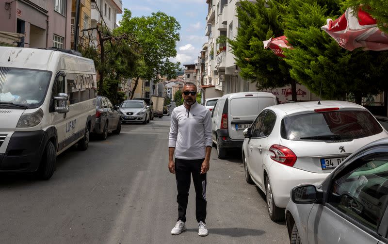 Hakan Yaman poses for a picture at the street where he was wounded during Gezi Park protests in Istanbul