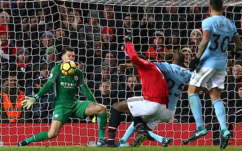 Manchester City goalkeeper Ederson, left, stops a shot from Manchester United's Romelu Lukaku - Credit: AP Photo/Dave Thompson