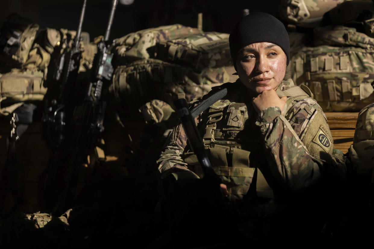A member of the 82nd Airborne Division of the U.S. Army relaxes ahead of deployment to Poland from Fort Bragg, N.C. on Monday, Feb. 14, 2022. (AP Photo/Nathan Posner)