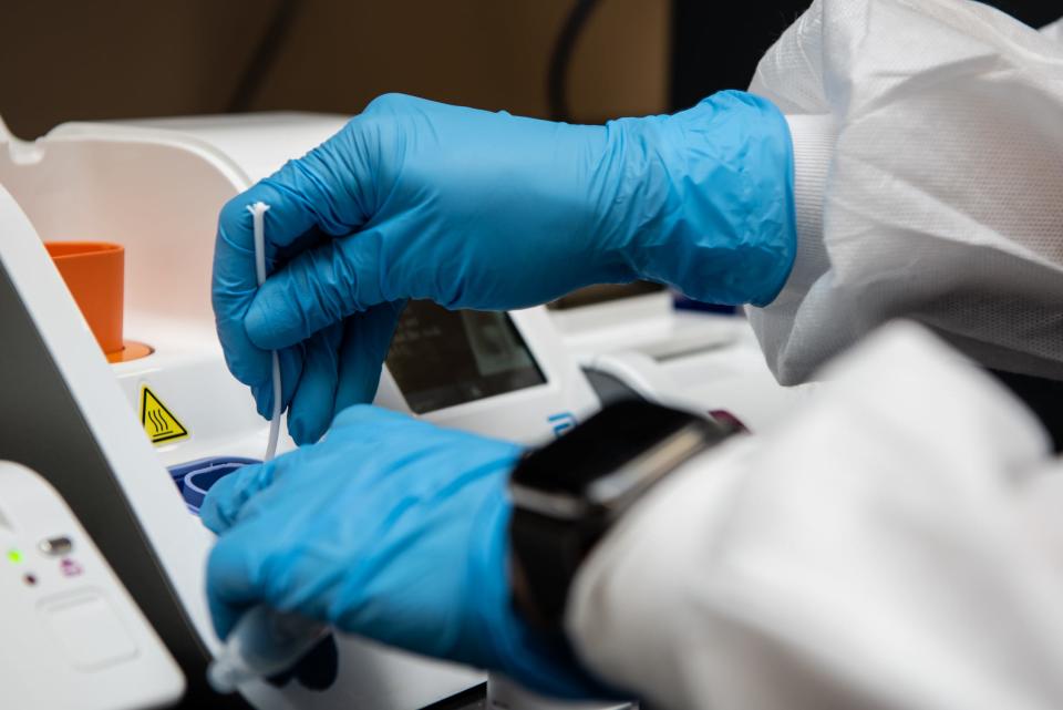 A speciman from a rapid PCR COVID-19 test is processed inside a lab at Doylestown Hospital on Monday, March 8, 2021.