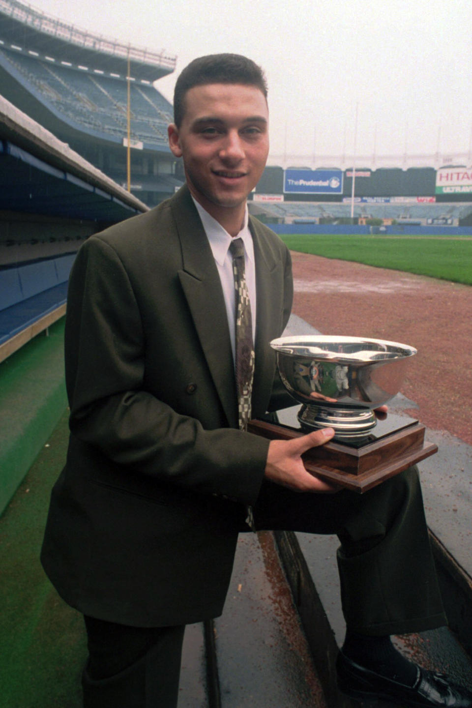 FILE - In this Sept. 14, 1994, file photo, New York Yankees prospect Derek Jeter poses on the dugout steps at Yankee Stadium in New York, where he was named Baseball America's minor league player of the year. Jeter could be a unanimous pick when Baseball Hall of Fame voting is announced Tuesday, Jan. 21, 2020. (AP Photo/Mark Lennihan)