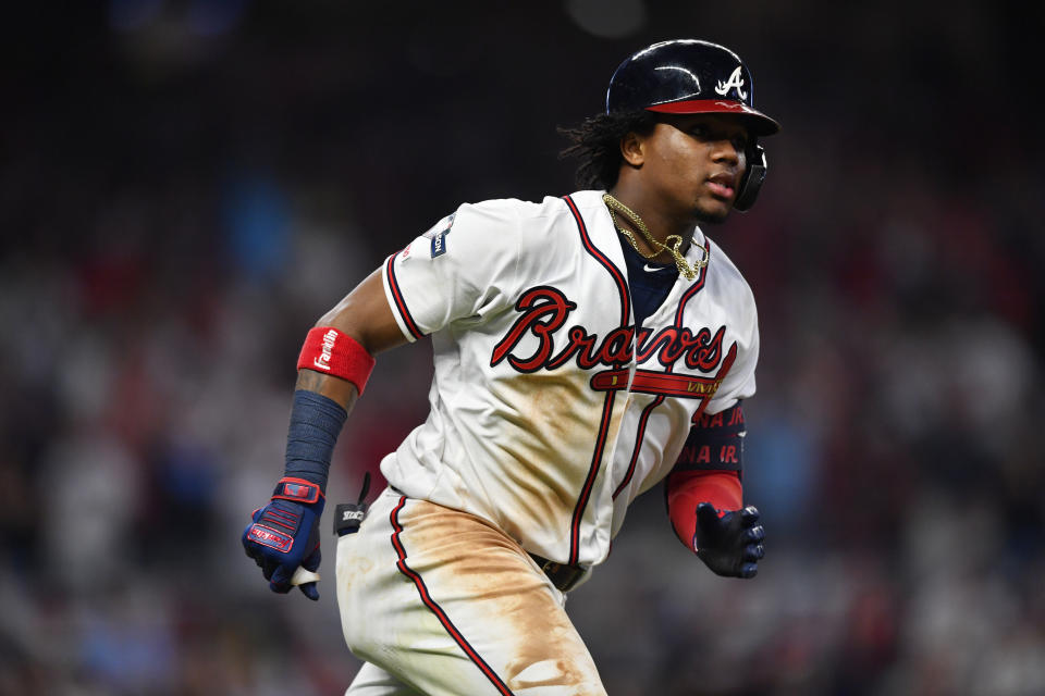 Atlanta Braves center fielder Ronald Acuna Jr. (13) runs to first base after a hit against the St. Louis Cardinals in the seventh inning during Game 1 of a best-of-five National League Division Series, Thursday, Oct. 3, 2019, in Atlanta. (AP Photo/John Amis)