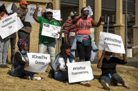 People protest against coronavirus trials in Africa, outside Chris Hani Baragwanath Hospita in the township of Soweto in Johannesburg, South Africa, Saturday, July 18, 2020, The first clinical trial in Africa for a COVID-19 vaccine started last week in South Africa. Experts note a worrying level of resistance and misinformation around testing on the continent. (AP Photo/Themba Hadebe)
