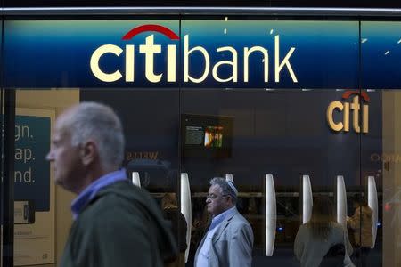 People walk past a Citibank branch in New York October 15, 2013. REUTERS/Andrew Kelly