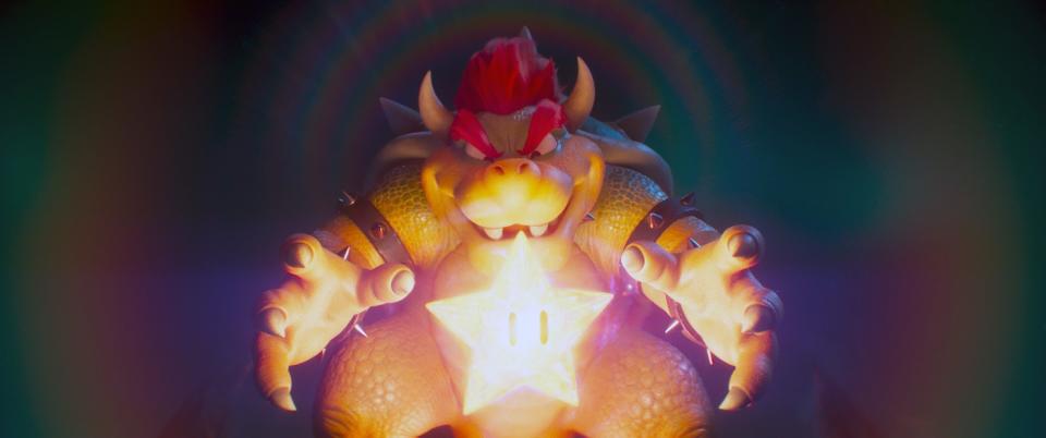 Bowser with his hands reaching toward a glowing super star