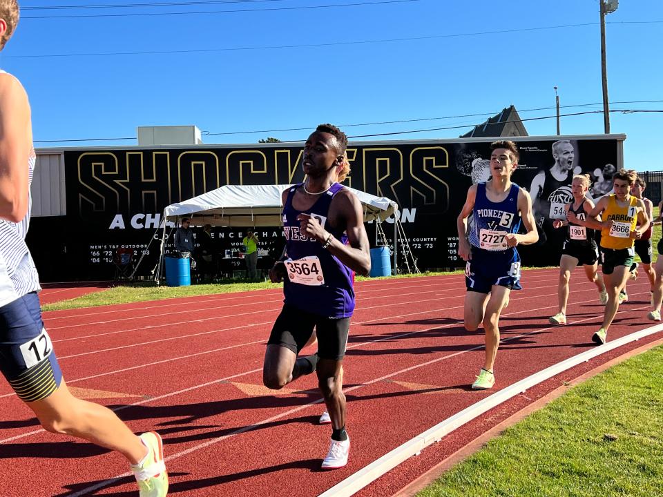 Topeka West junior Lenny Njoroge races in the 3200 finals on Friday.