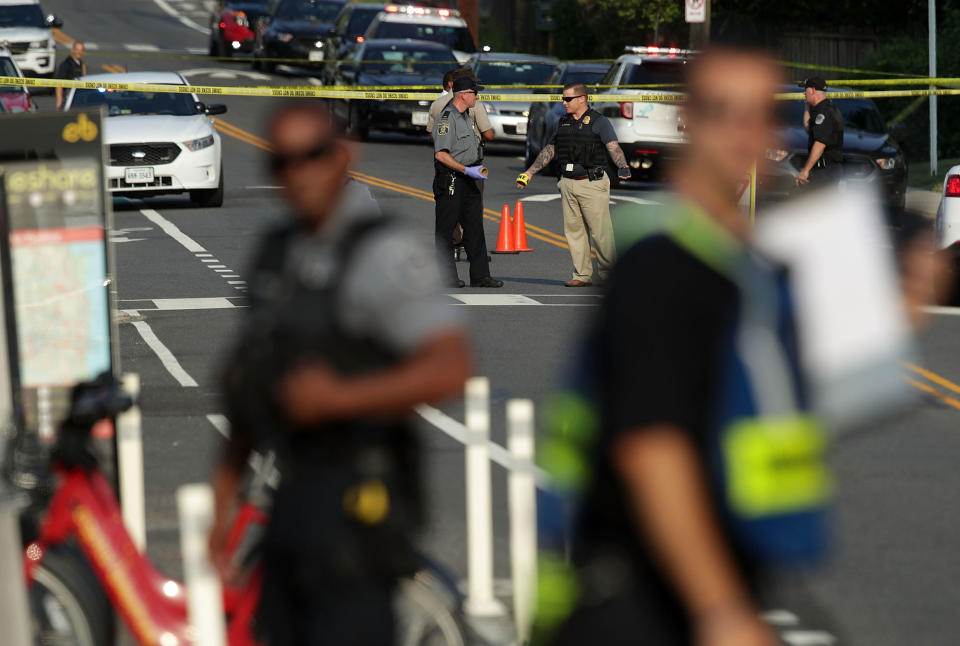<p>Investigators gather near the scene of an opened fire June 14, 2017 in Alexandria, Virginia. Multiple injuries were reported from the instance. (Photo: Alex Wong/Getty Images) </p>