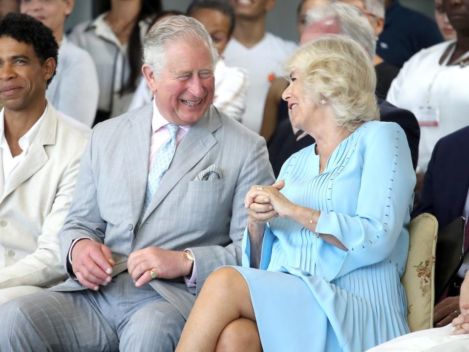 Prince Charles and Camilla laugh together at an event